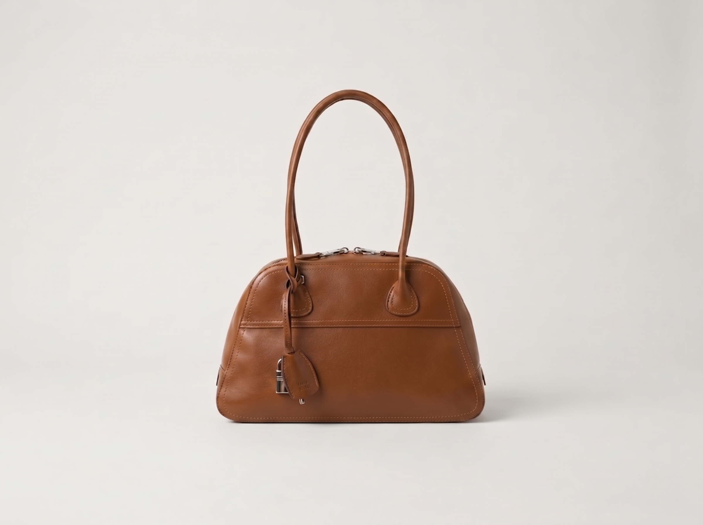 Brown leather top handle bag with a structured.